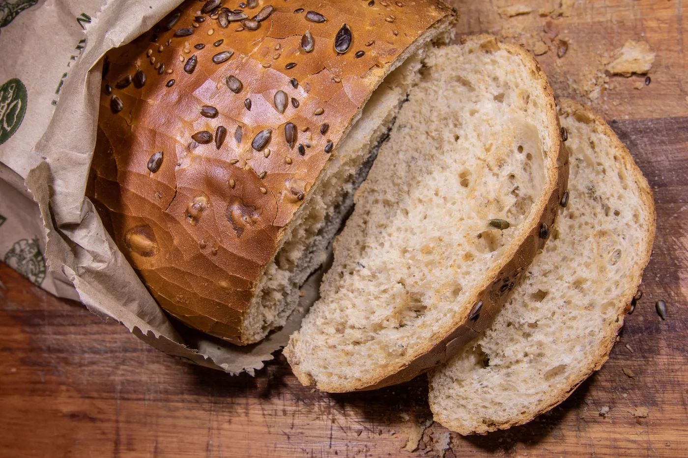 Artisan oat bread sliced ​​on wooden board